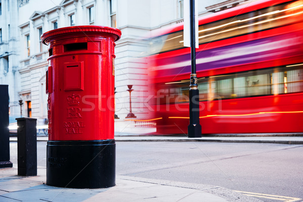 Traditional red mail letter box and red bus in motion in London, the UK. Stock photo © photocreo
