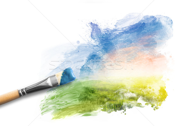 Painting the spring landscape. Brush with blue paint over sky and green field Stock photo © photocreo