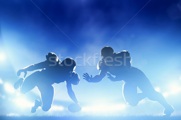 Stock photo: American football players in game, touchdown. Stadium lights
