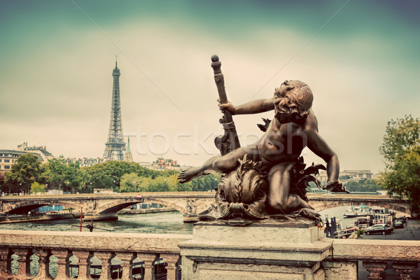 Statue on Pont Alexandre III bridge in Paris, France. Seine river and Eiffel Tower.  Stock photo © photocreo