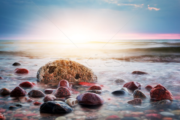Dramatic colorful sunset on a rocky beach. Baltic sea Stock photo © photocreo
