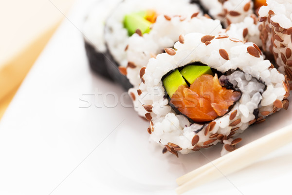 Stock photo: Sushi with salmon, avocado, rice in seaweed served with wasabi and ginger. 