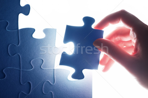 Completing the last piece of jigsaw puzzle. Solution, solving the problem. Stock photo © photocreo