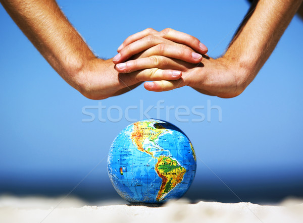 Earth globe with hands over it. Conceptual image Stock photo © photocreo