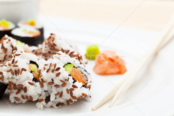 Stock photo: Sushi with salmon, avocado, rice in seaweed served with wasabi and ginger. 