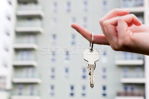 A real estate agent holding keys to a new apartment in her hands. Stock photo © photocreo