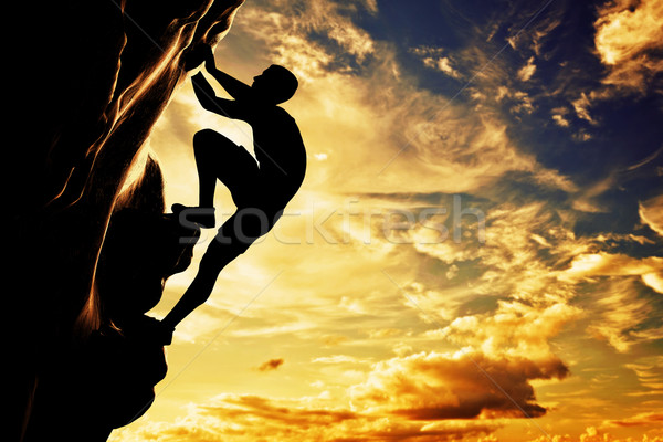 Silhueta homem livre escalada rocha montanha Foto stock © photocreo