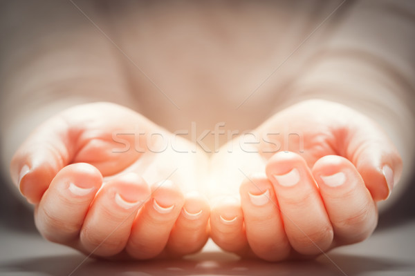 Light in woman's hands. Concepts of sharing, giving, new life Stock photo © photocreo