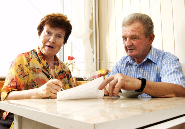 Senior couple signing document Stock photo © photocreo