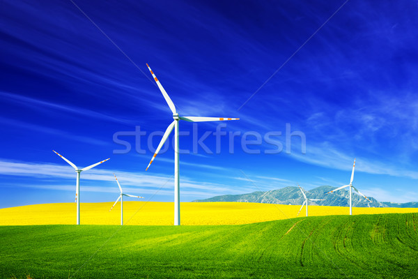 Wind turbines on spring field. Alternative, clean and natural energy Stock photo © photocreo