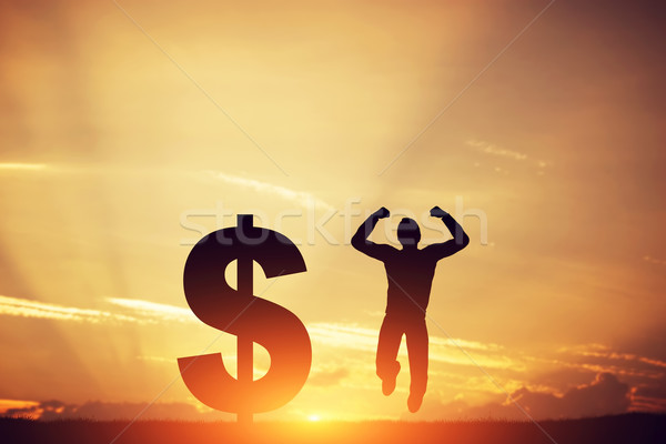 Man jumping for joy next to dollar symbol. Winner of lottery Stock photo © photocreo