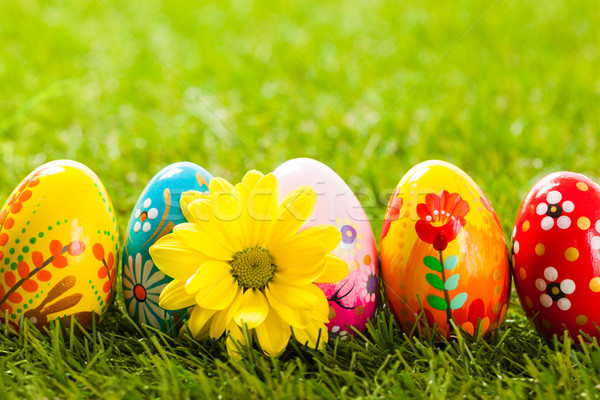 Colorful hand painted Easter eggs and spring flowers in grass Stock photo © photocreo