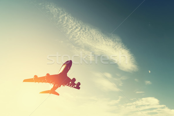Airplane taking off at sunset. Silhouette of a flying passenger or cargo aircraft, airline Stock photo © photocreo