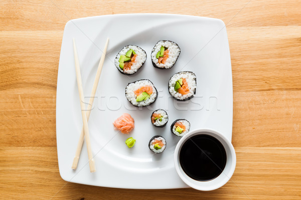 Sushi with salmon, avocado, rice in seaweed served with wasabi and ginger.  Stock photo © photocreo