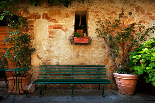 Retro bench outside old Italian house in a small town of Pienza, Italy. Vintage Stock photo © photocreo