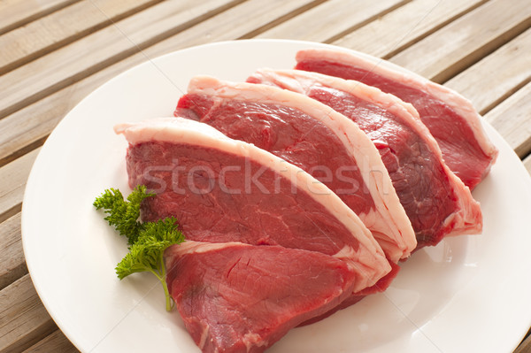 Four fresh raw beef steaks Stock photo © photohome