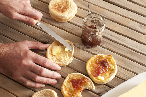 Hands spreading butter on english muffins Stock photo © photohome