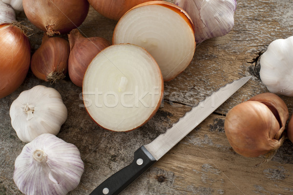 Onions, Garlic and Sharp Knife on Wood Table Stock photo © photohome