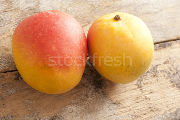 Two fresh whole sweet tropical mangoes Stock photo © photohome