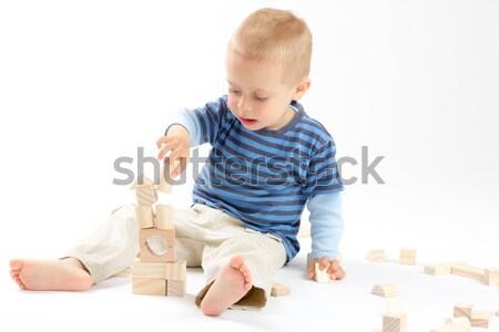 Little cute boy playing with building blocks. Isolated on white. Stock photo © Photoline