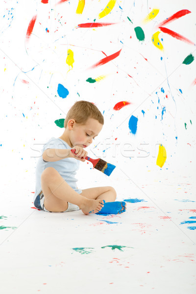 Stock photo: Adorable 3 year old boy child creatively stains on the wall.