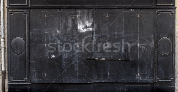 Antique black wooden doors of a store. Stock photo © Photooiasson