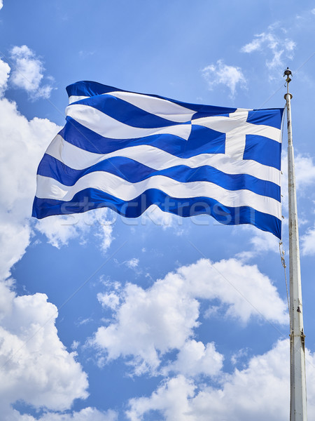 Flag of Greece waving on a blue sky. Stock photo © Photooiasson