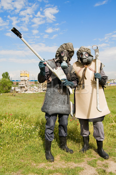 Stock photo: Nuclear protection crew in old protective suits and gas mask