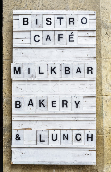 Bistro wooden panel on a stone wall. Stock photo © Photooiasson
