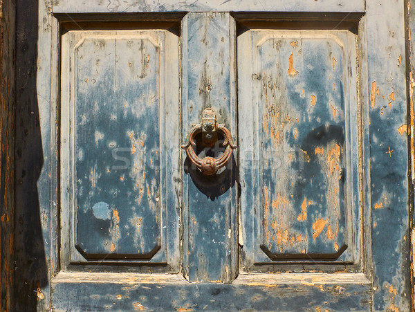 Antique blue door with a rusty metal ring knob background. Stock photo © Photooiasson