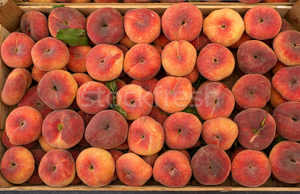 Fresh saturn peaches in a market. Stock photo © Photooiasson