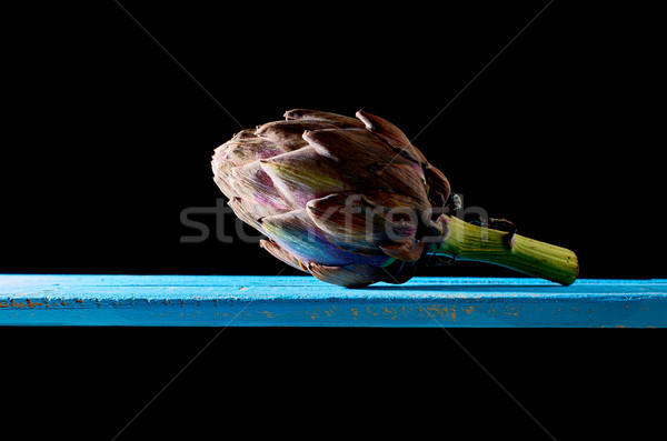 Purple artichoke at backlight in a darkness ambient. Stock photo © Photooiasson