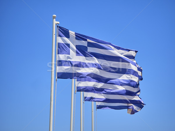 Flag of Greece waving on a blue sky. Stock photo © Photooiasson