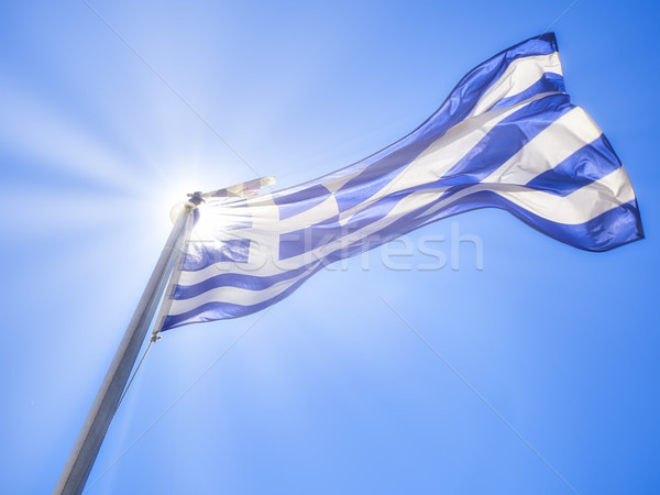 Flag of Greece waving on a blue sky. Stock photo © Photooiasson