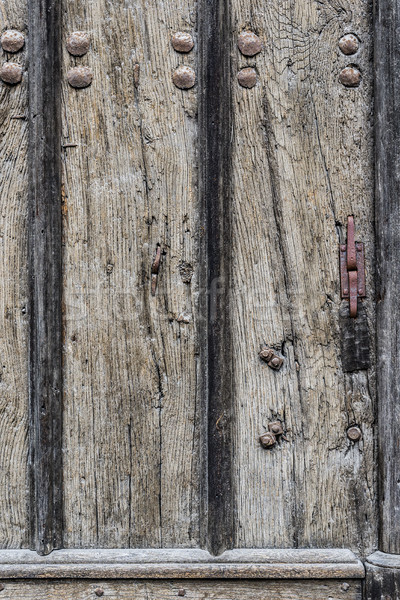Weathered wooden door background with a metallic rusty rivets.  Stock photo © Photooiasson
