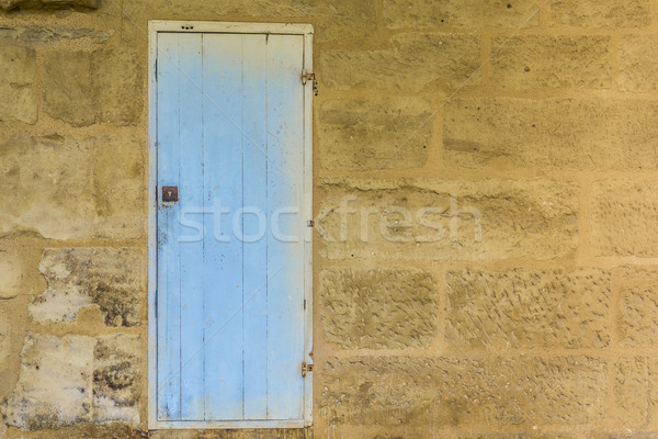 Weathered wooden door with blue paint chipped and peeling. Stock photo © Photooiasson