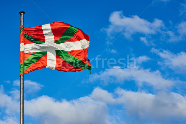 Ikurrina, Basque Country flag waving on a blue sky. Stock photo © Photooiasson