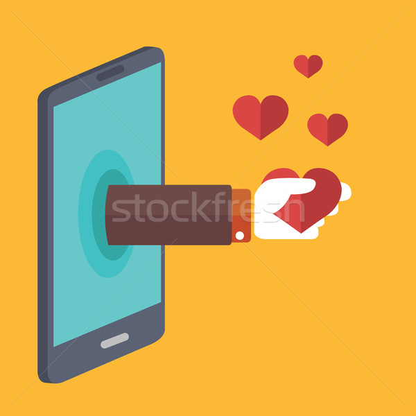 Hand sticking out of smartphone, holding heart, favorite Stock photo © Photoroyalty