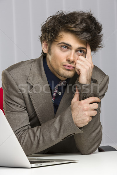 Contemplative handsome young business guy Stock photo © photosebia