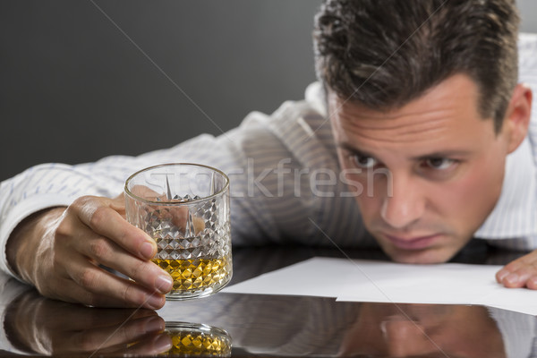 Sad businessman drinking alcohol Stock photo © photosebia
