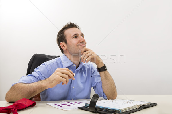 Young executive lost in happy thoughts Stock photo © photosebia