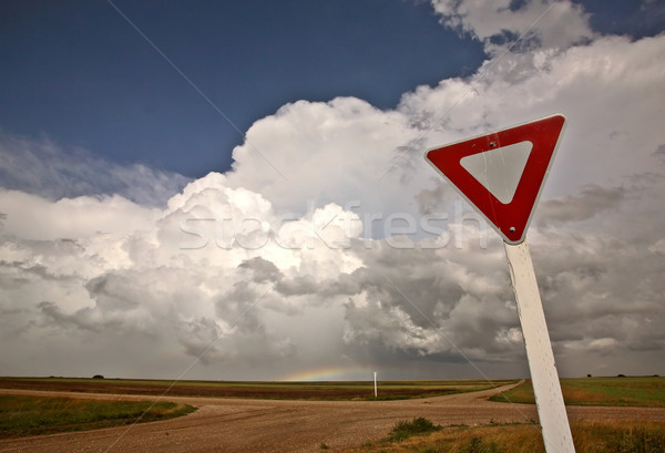 Yeild sign with Cumuloninumbus clouds in background Stock photo © pictureguy
