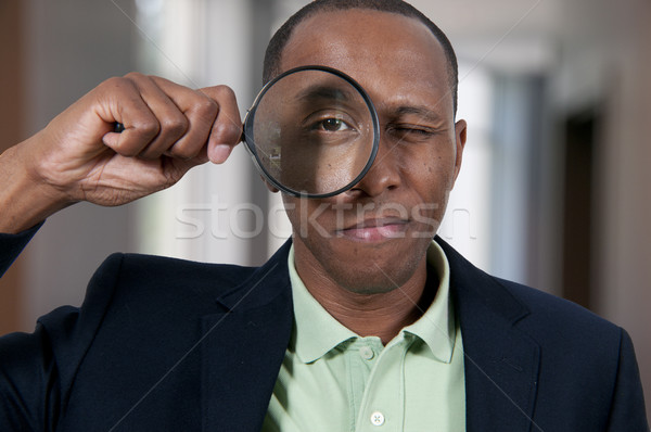 Black Man Looking through a magnifying glass Stock photo © piedmontphoto