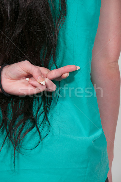 Stock photo: Woman with fingers crossed