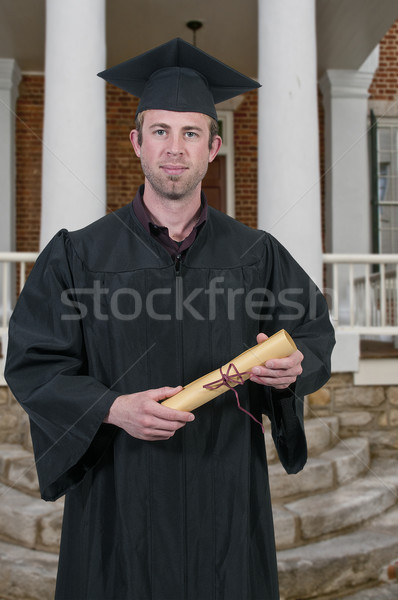 Afgestudeerde jonge man afstuderen man student succes Stockfoto © piedmontphoto