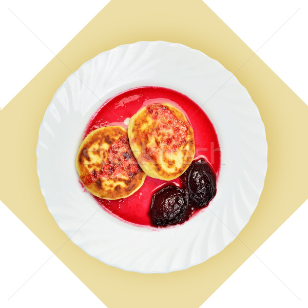 Dish of pancakes with cherry sause on white plate. Stock photo © Pilgrimego