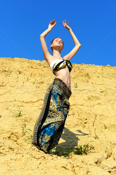 Beautiful woman dancing on the san Stock photo © Pilgrimego