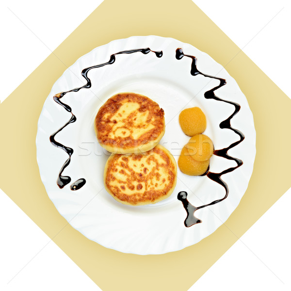 Dish of pancakes with dried apricot on white plate. Stock photo © Pilgrimego