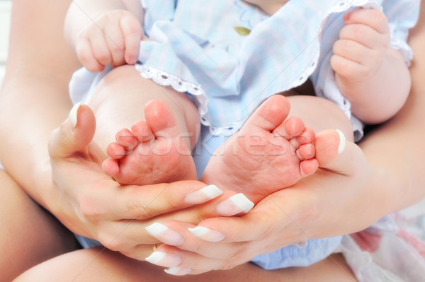 Stock photo: Mother holding her Baby's feet.