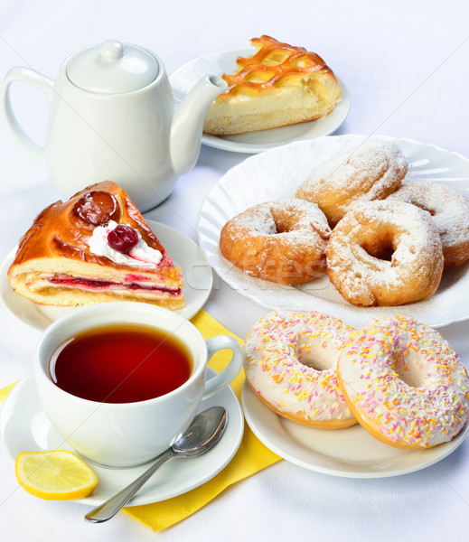 still life of setout table with baking pies, donuts, tee cup and Stock photo © Pilgrimego